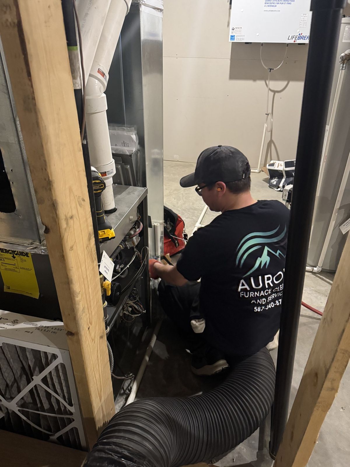 Aurora technician working on a residential furnace